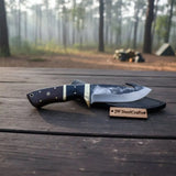 Gut hook knife with wood and brass handle.